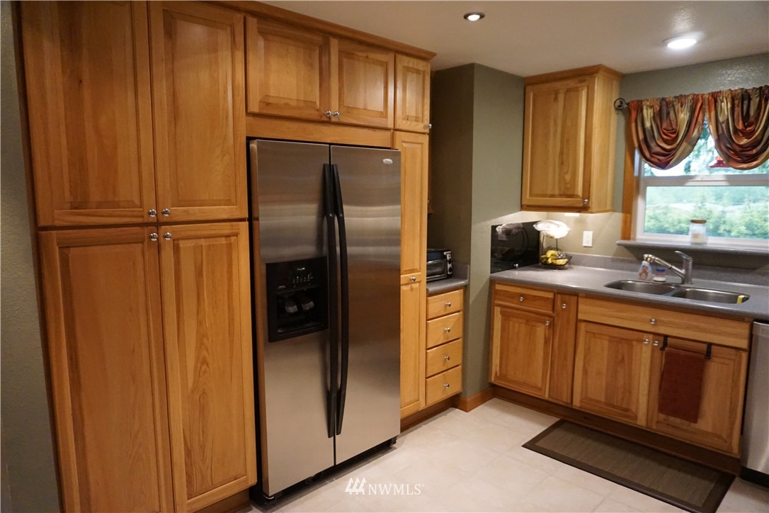 17813 Butler Road Snohomish, WA 98290 - Photo 4 of 23 a kitchen with stainless steel appliances granite countertop a refrigerator and a sink