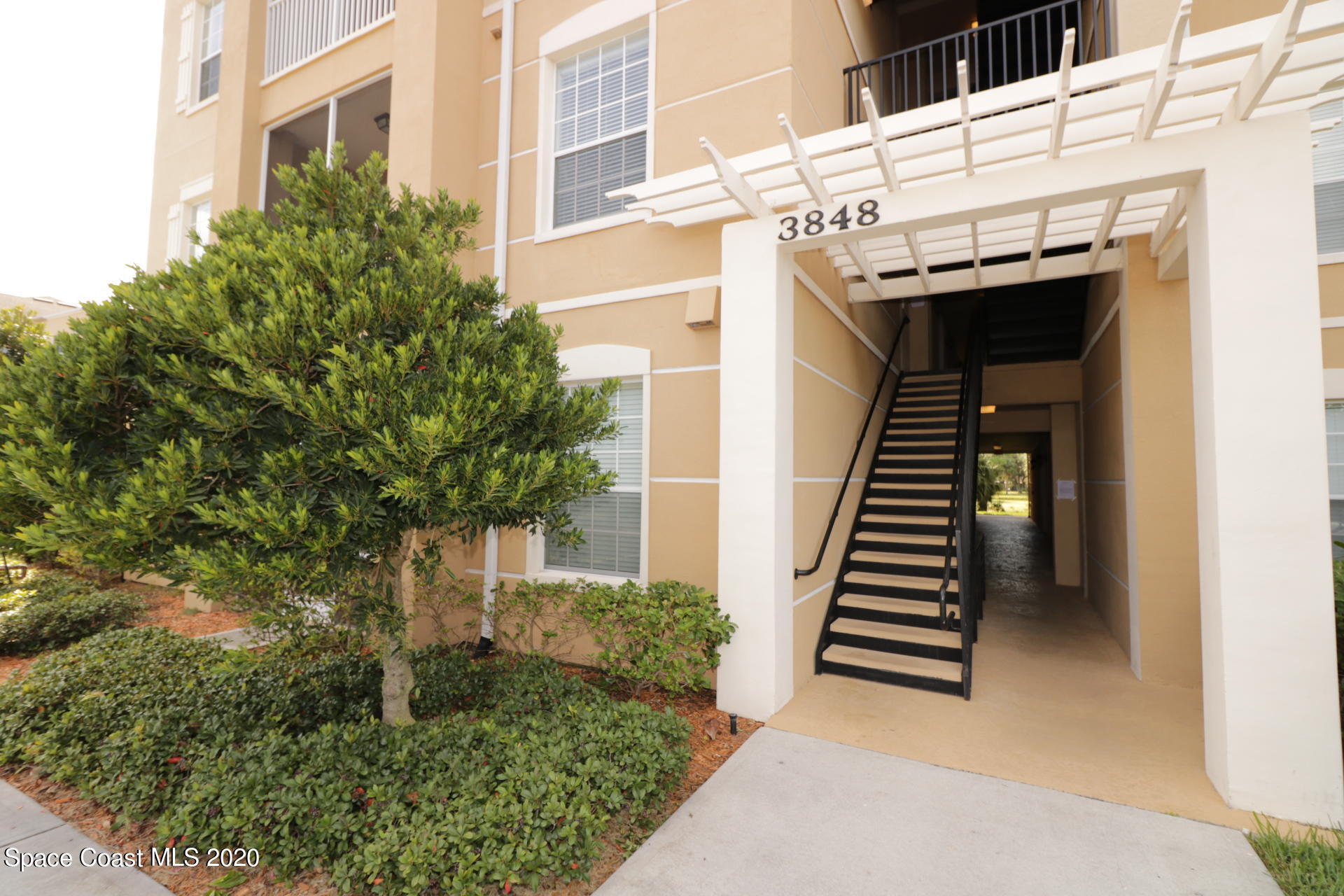 3848 Lexmark Lane, Unit 401 Rockledge, FL 32955 - Photo 2 of 23 a view of a pathway of building