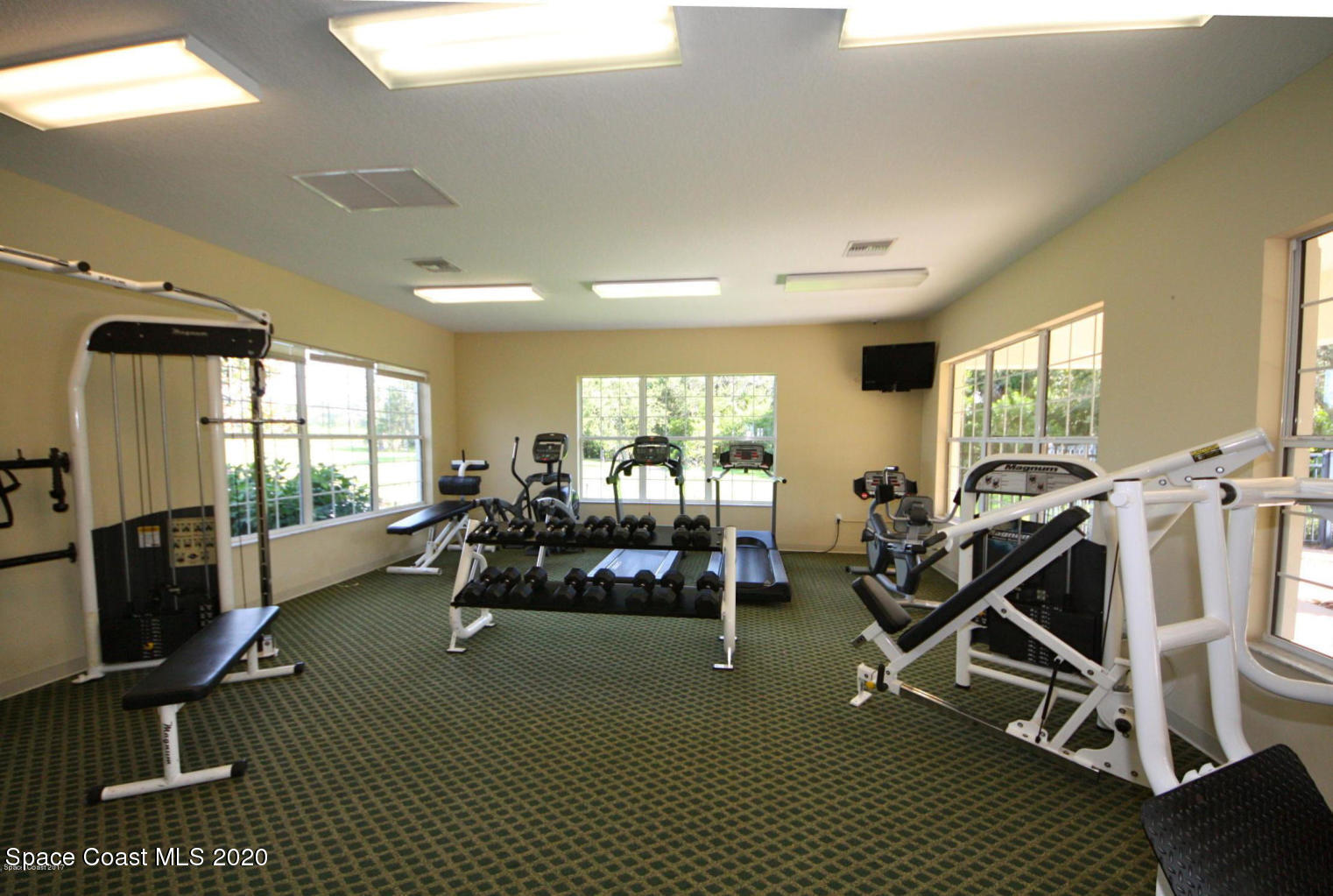 3848 Lexmark Lane, Unit 401 Rockledge, FL 32955 - Photo 22 of 23 a living room with furniture gym equipment and a large window