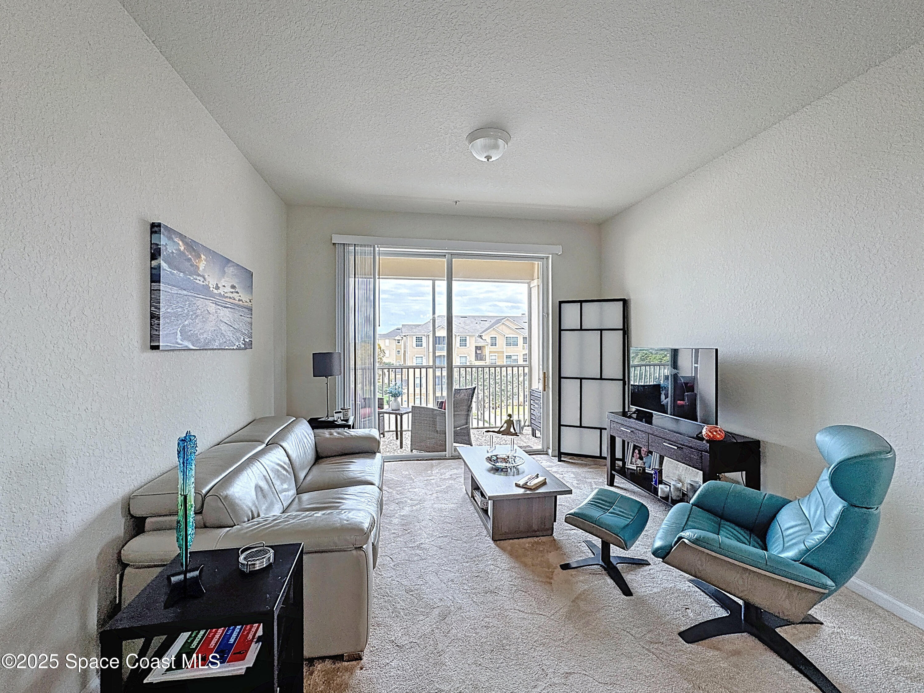 3848 Lexmark Lane, Unit 401 Rockledge, FL 32955 - Photo 10 of 23 a living room with furniture and a floor to ceiling window
