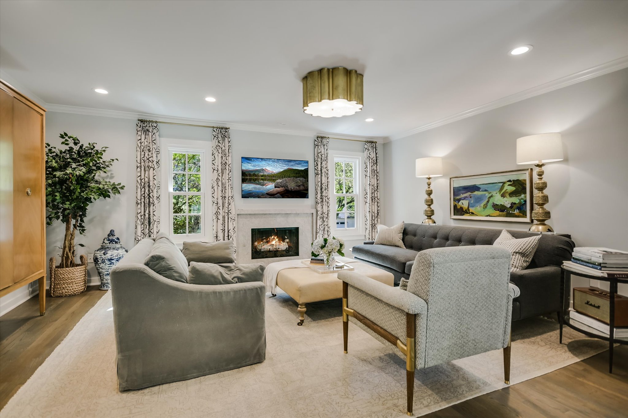 1710 McCall Road Austin, TX 78703 - Photo 1 of 1 Living area featuring plenty of natural light, ornamental molding, and wood finished floors
