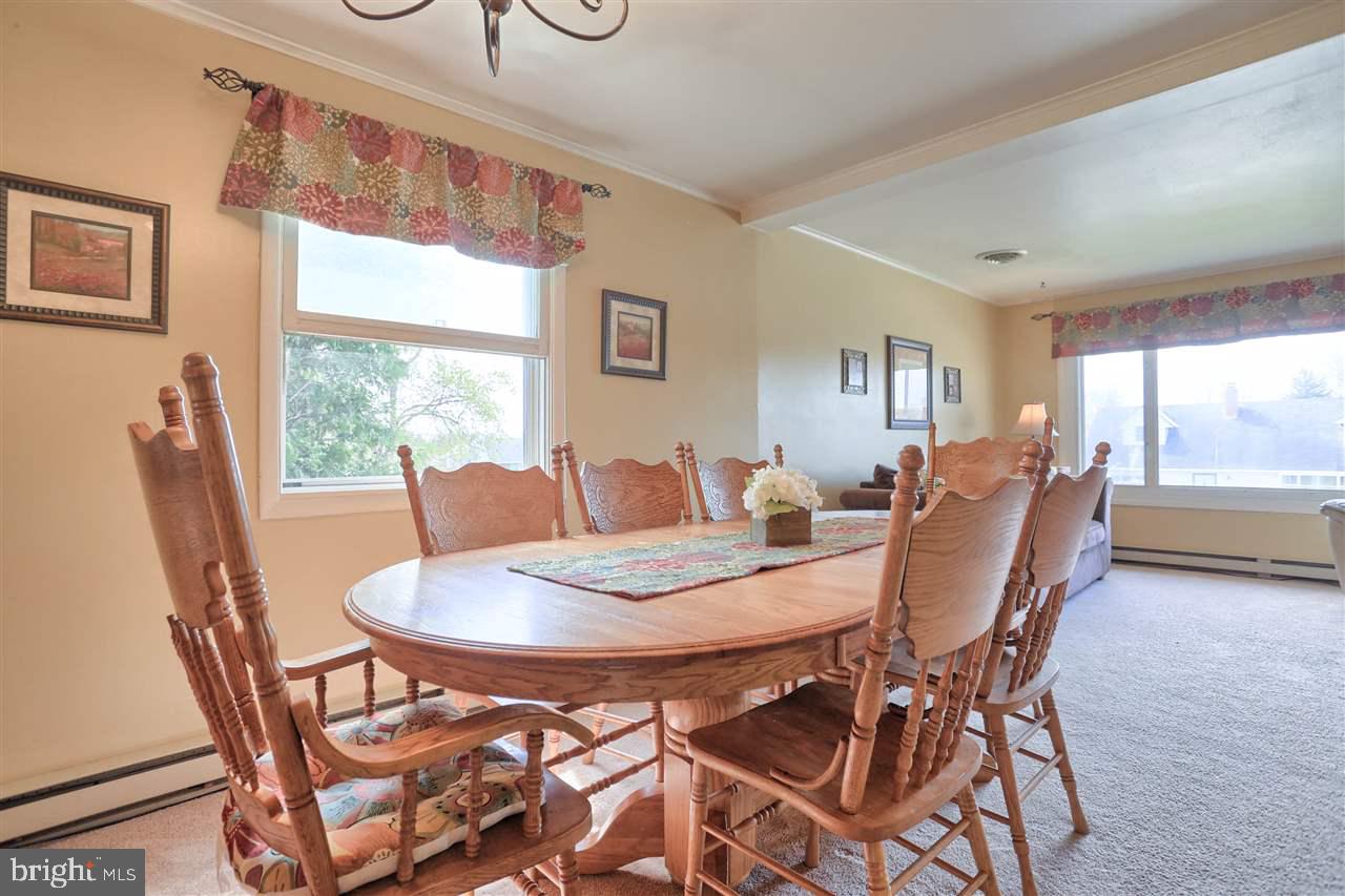 1409 Wogan Road York, PA 17404 - Photo 11 of 36 a view of a dining room with furniture a rug and wooden floor