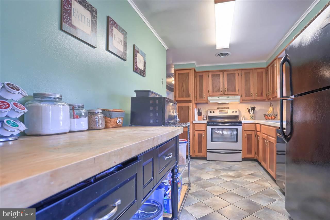 1409 Wogan Road York, PA 17404 - Photo 12 of 36 a kitchen with stainless steel appliances granite countertop a refrigerator and a stove