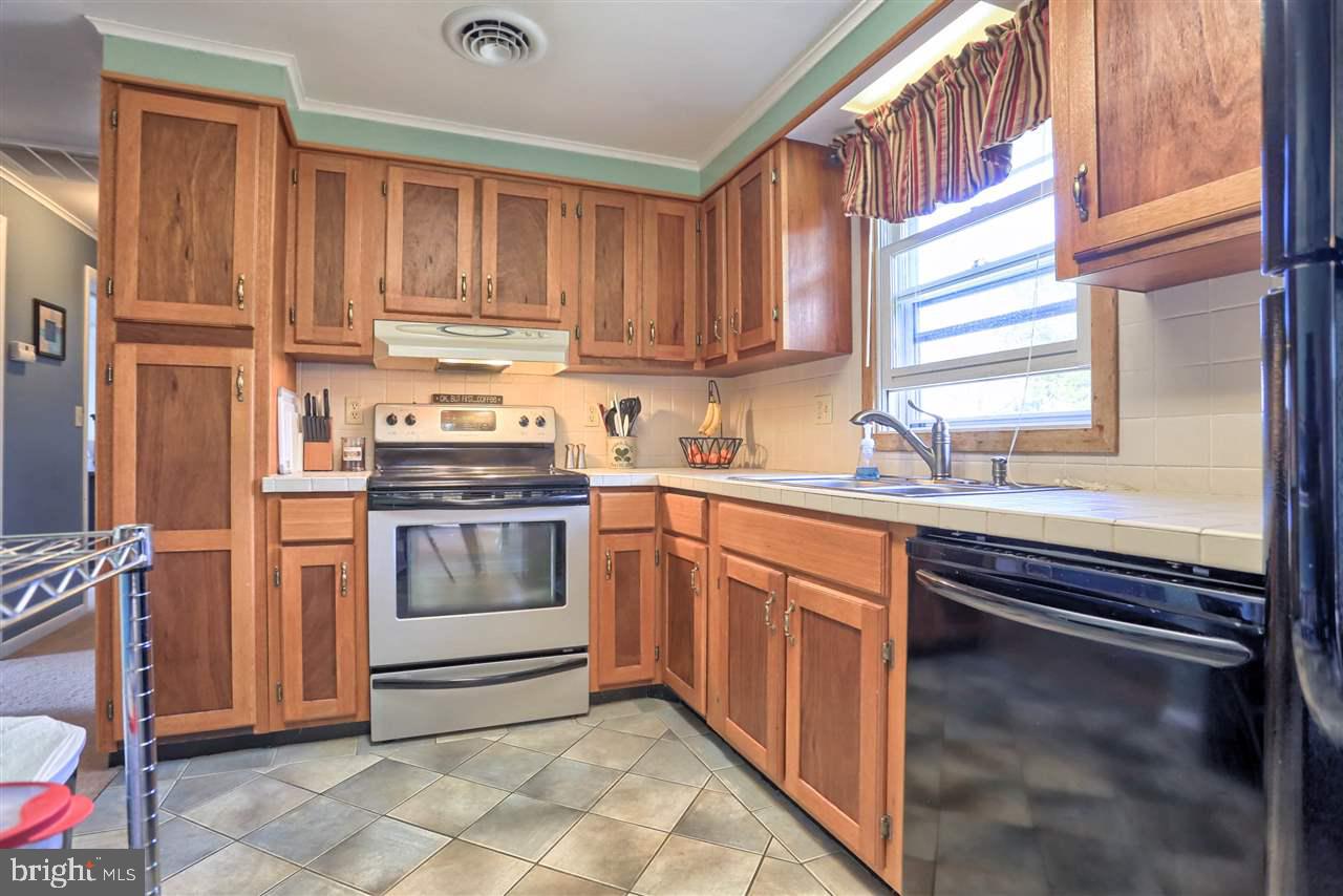 1409 Wogan Road York, PA 17404 - Photo 13 of 36 a kitchen with a sink stove and cabinets