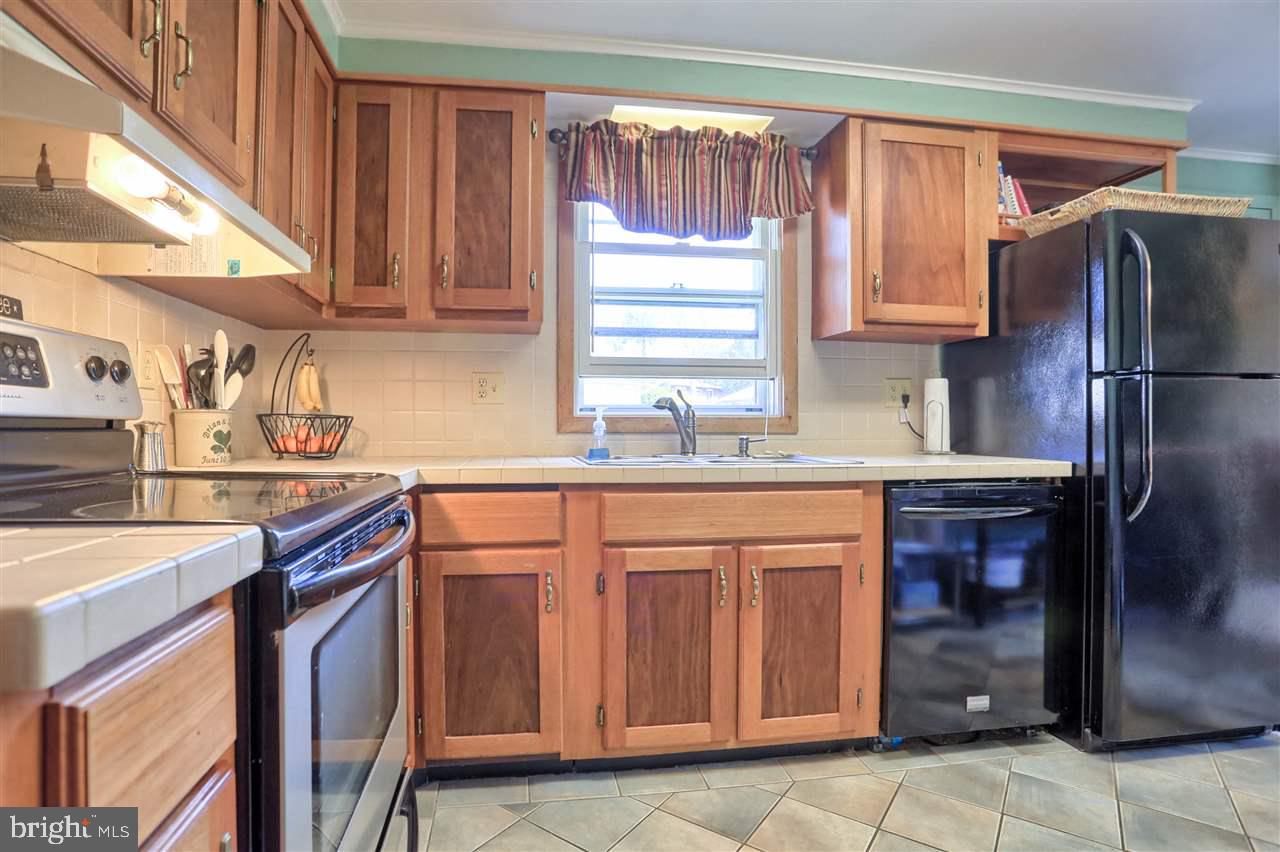 1409 Wogan Road York, PA 17404 - Photo 14 of 36 a kitchen with stainless steel appliances granite countertop a sink a stove a refrigerator and cabinets