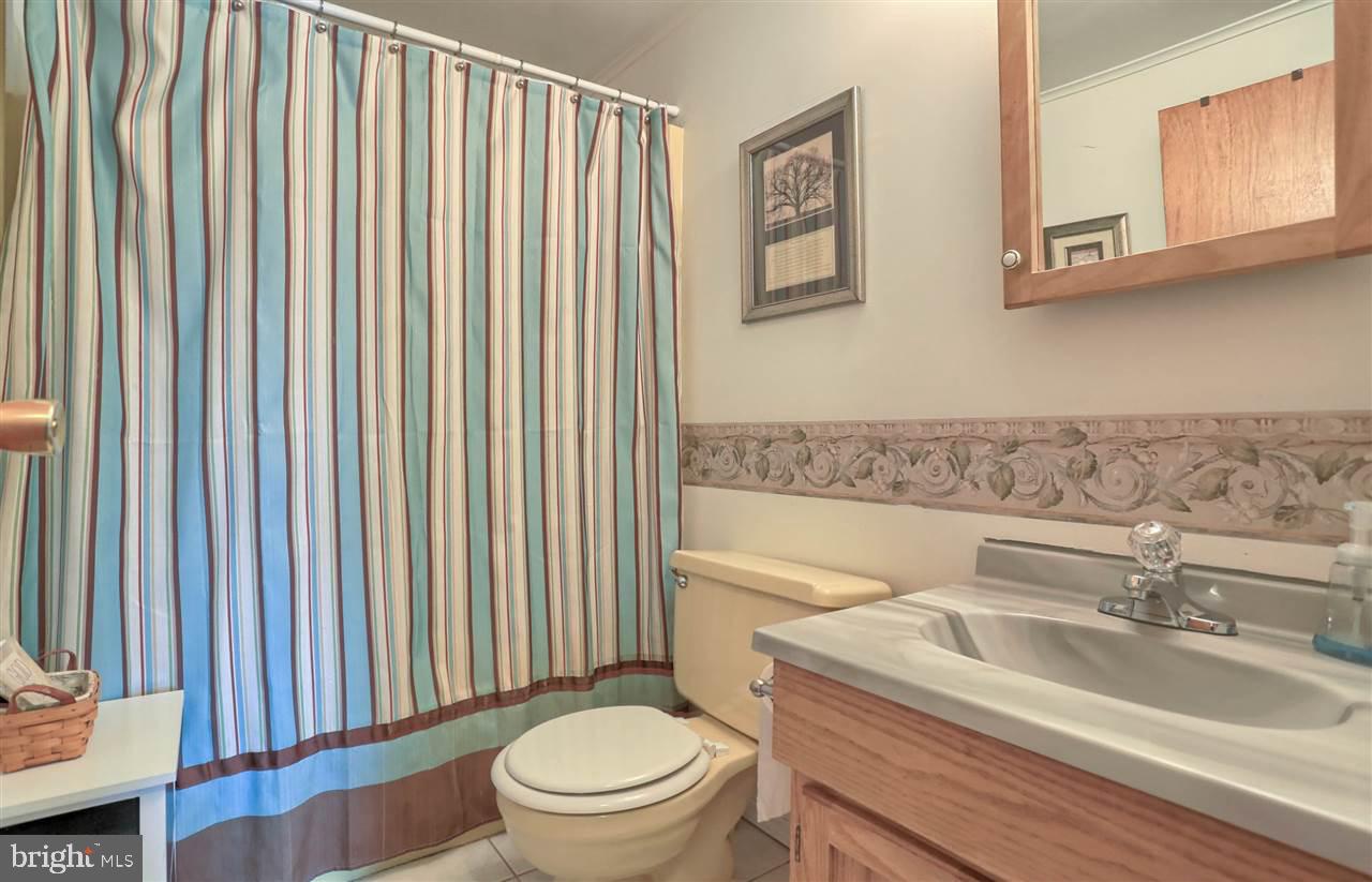 1409 Wogan Road York, PA 17404 - Photo 18 of 36 a bathroom with a toilet a sink and mirror