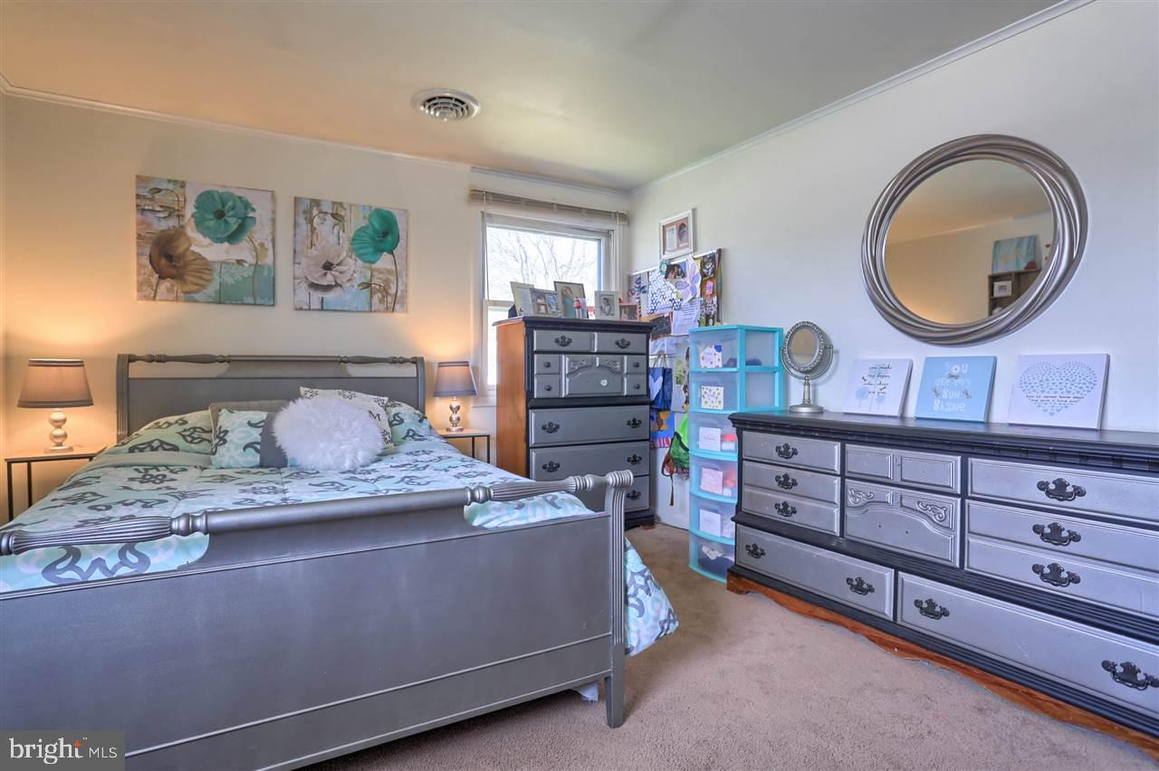 1409 Wogan Road York, PA 17404 - Photo 21 of 36 a bedroom with a bed and a dresser
