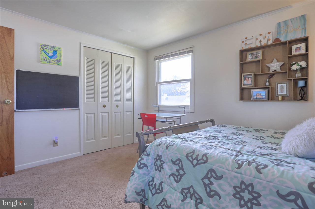 1409 Wogan Road York, PA 17404 - Photo 22 of 36 a bedroom with a bed and a window