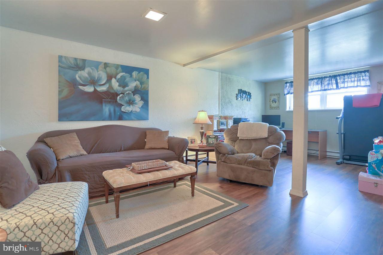 1409 Wogan Road York, PA 17404 - Photo 26 of 36 a living room with furniture and a painting on the wall
