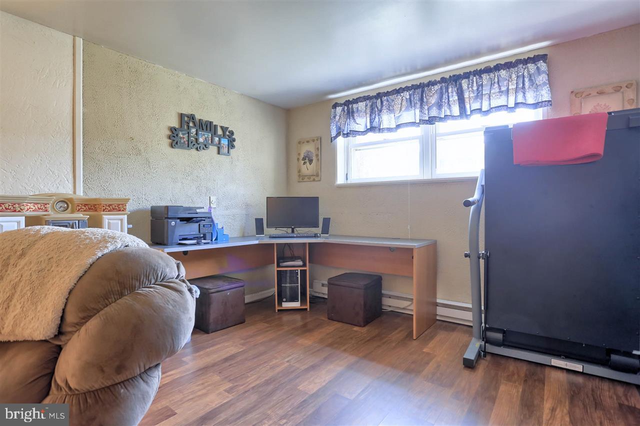 1409 Wogan Road York, PA 17404 - Photo 27 of 36 a living room with furniture and a fireplace