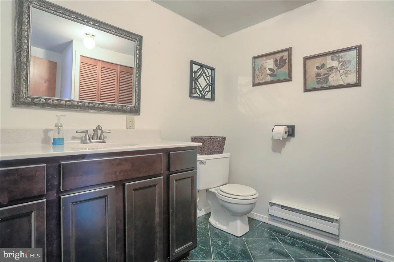 1409 Wogan Road York, PA 17404 - Photo 29 of 36 a bathroom with a granite countertop toilet sink and a mirror