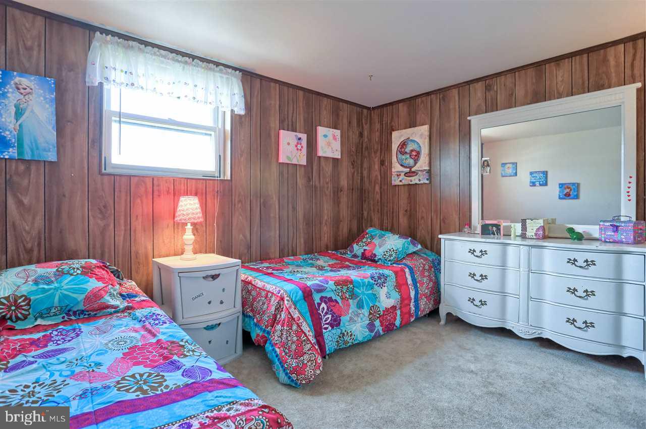 1409 Wogan Road York, PA 17404 - Photo 31 of 36 a bedroom with a bed and a dresser in it