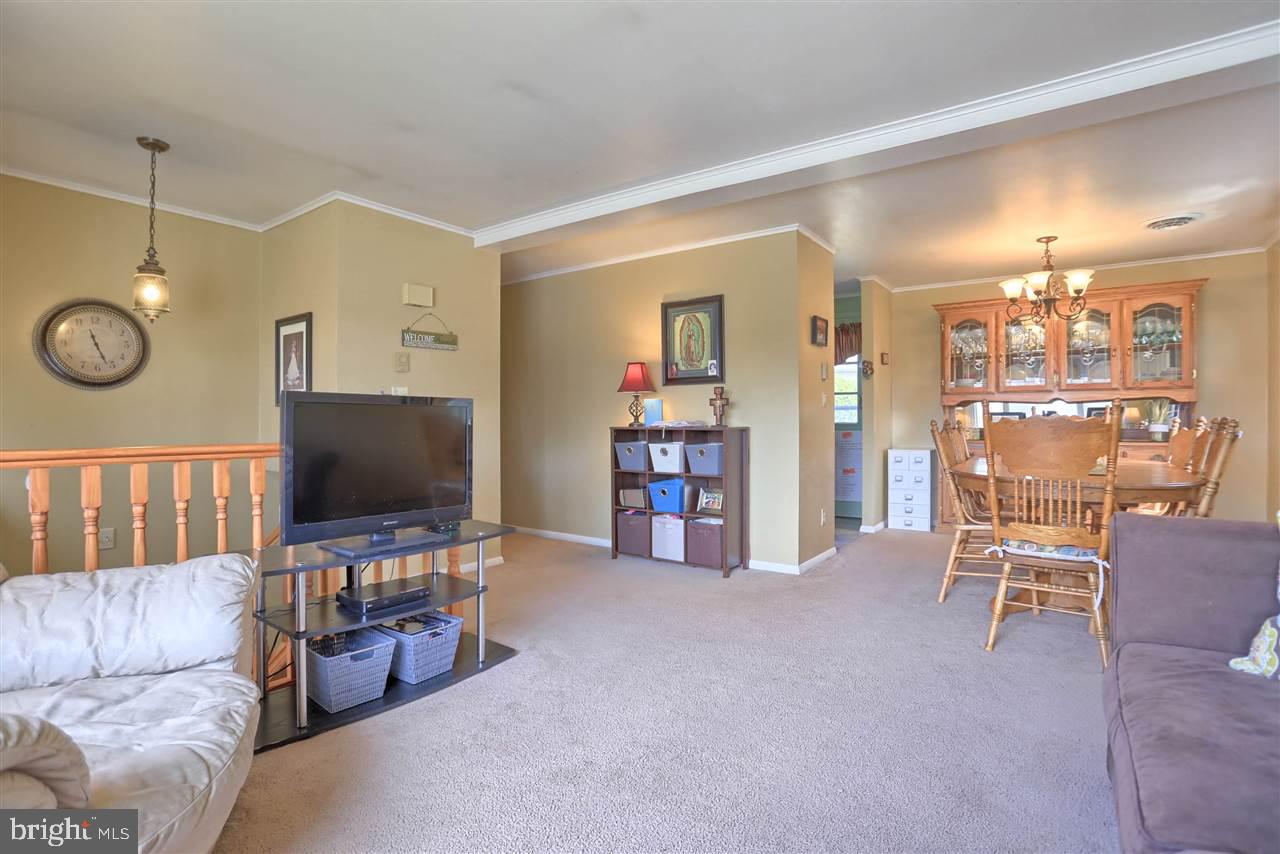 1409 Wogan Road York, PA 17404 - Photo 6 of 36 a living room with furniture and a flat screen tv