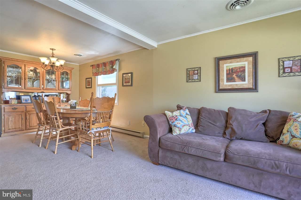 1409 Wogan Road York, PA 17404 - Photo 7 of 36 a living room with furniture a chandelier and a dining table