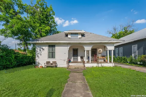a front view of a house with garden and porch