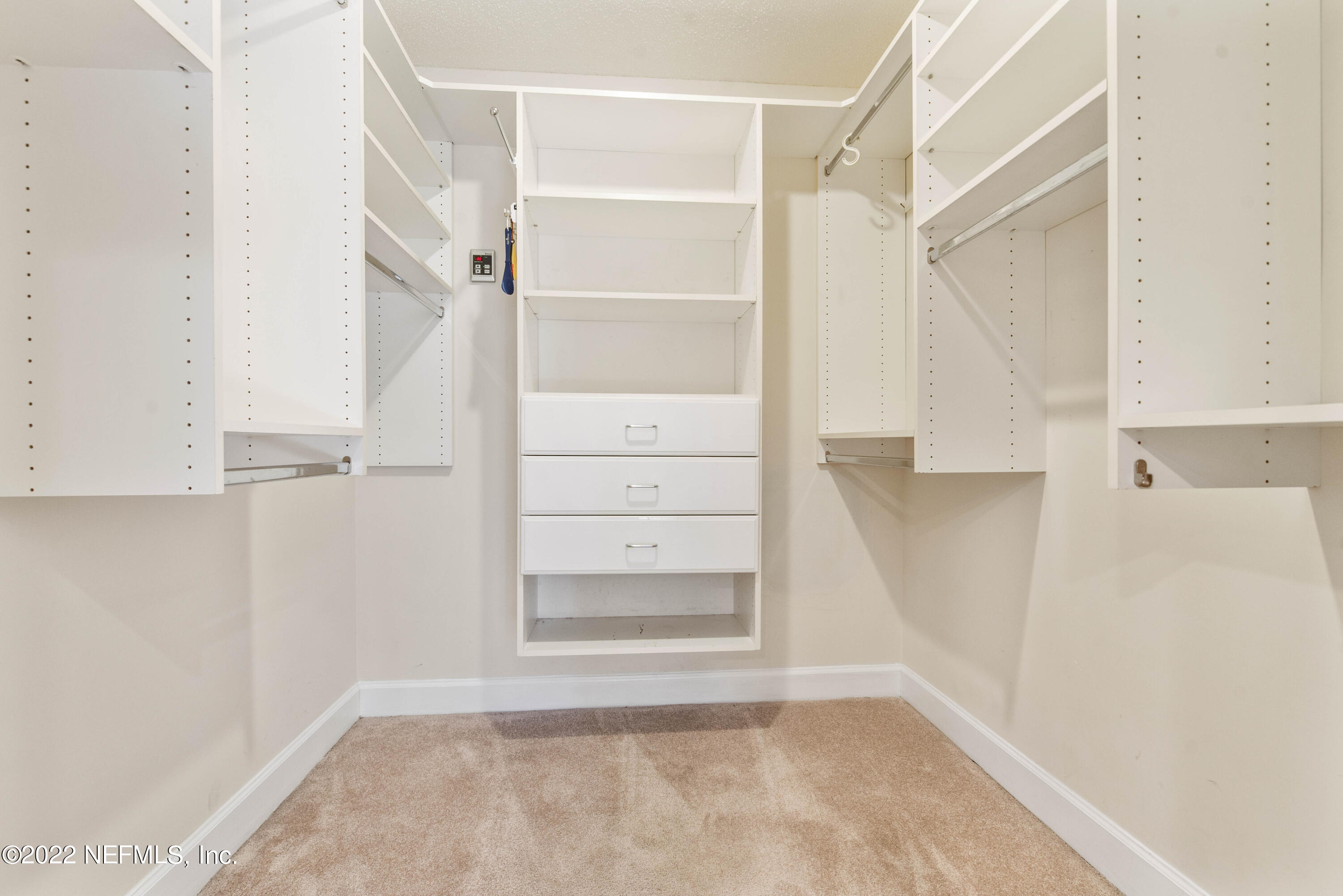 12608 Mandarin Road Jacksonville, FL 32223 - Photo 18 of 55 a view of walk in closet with empty racks