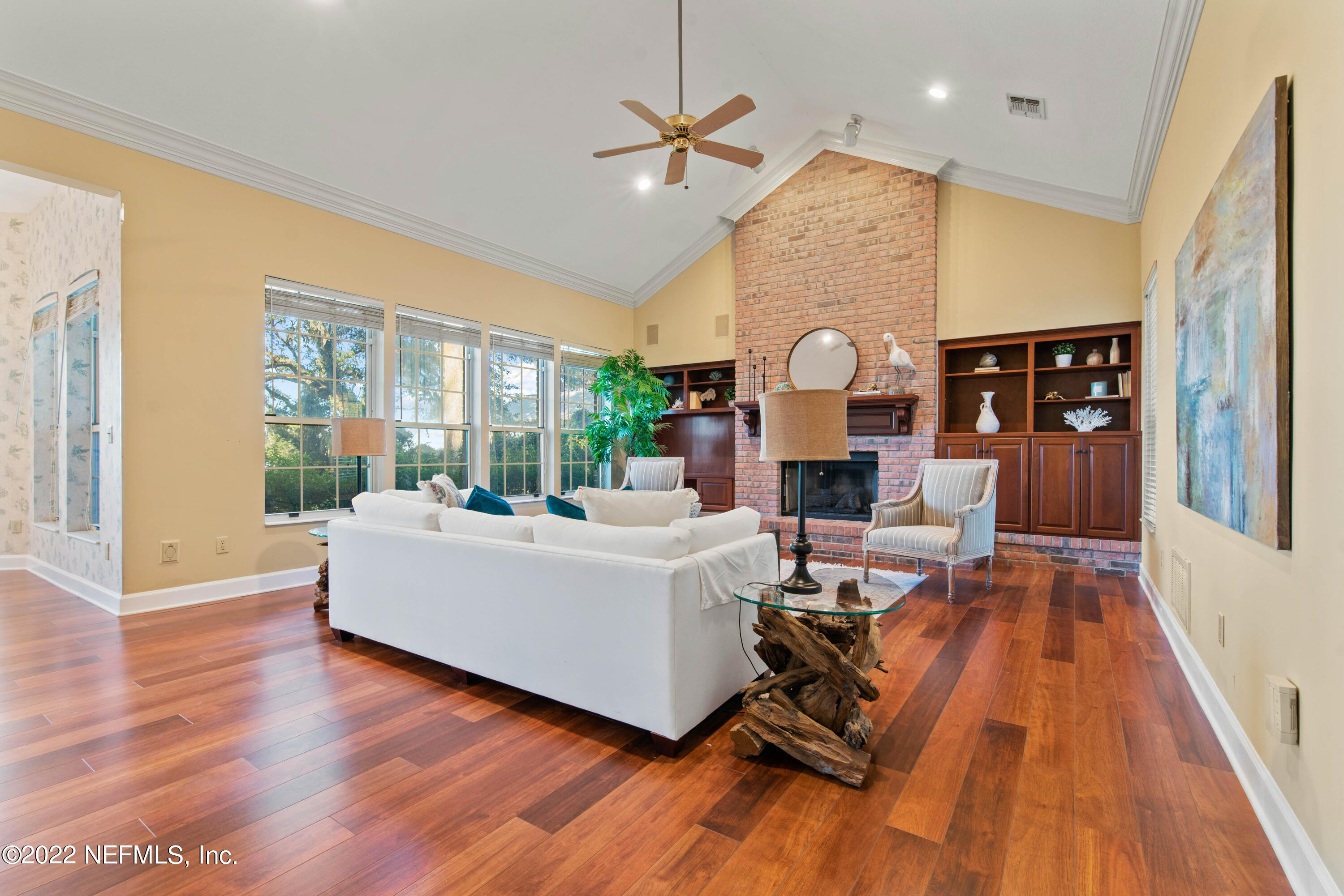 12608 Mandarin Road Jacksonville, FL 32223 - Photo 20 of 55 a living room with fireplace furniture wooden floor and a large window