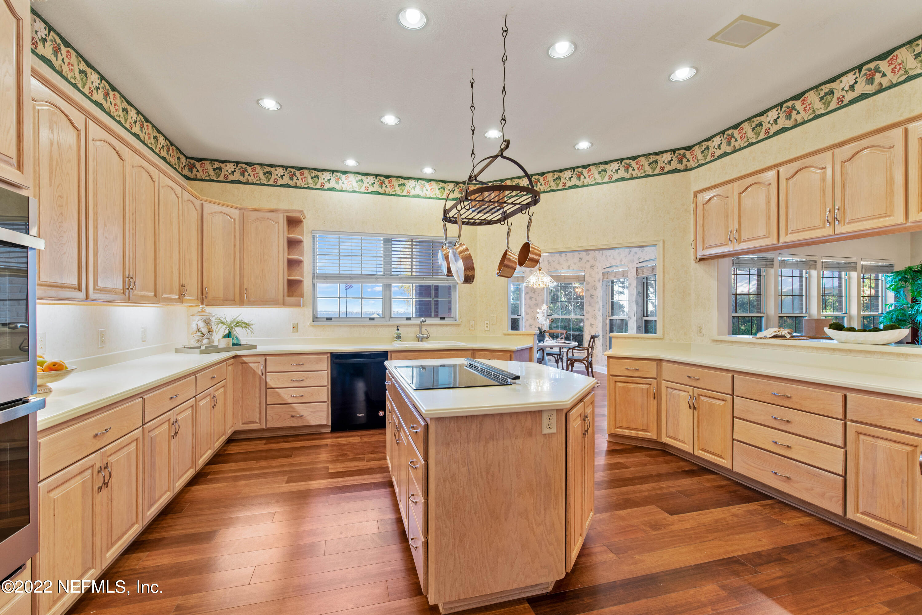 12608 Mandarin Road Jacksonville, FL 32223 - Photo 22 of 55 a large kitchen with stainless steel appliances lots of white cabinets wooden floor and a sink