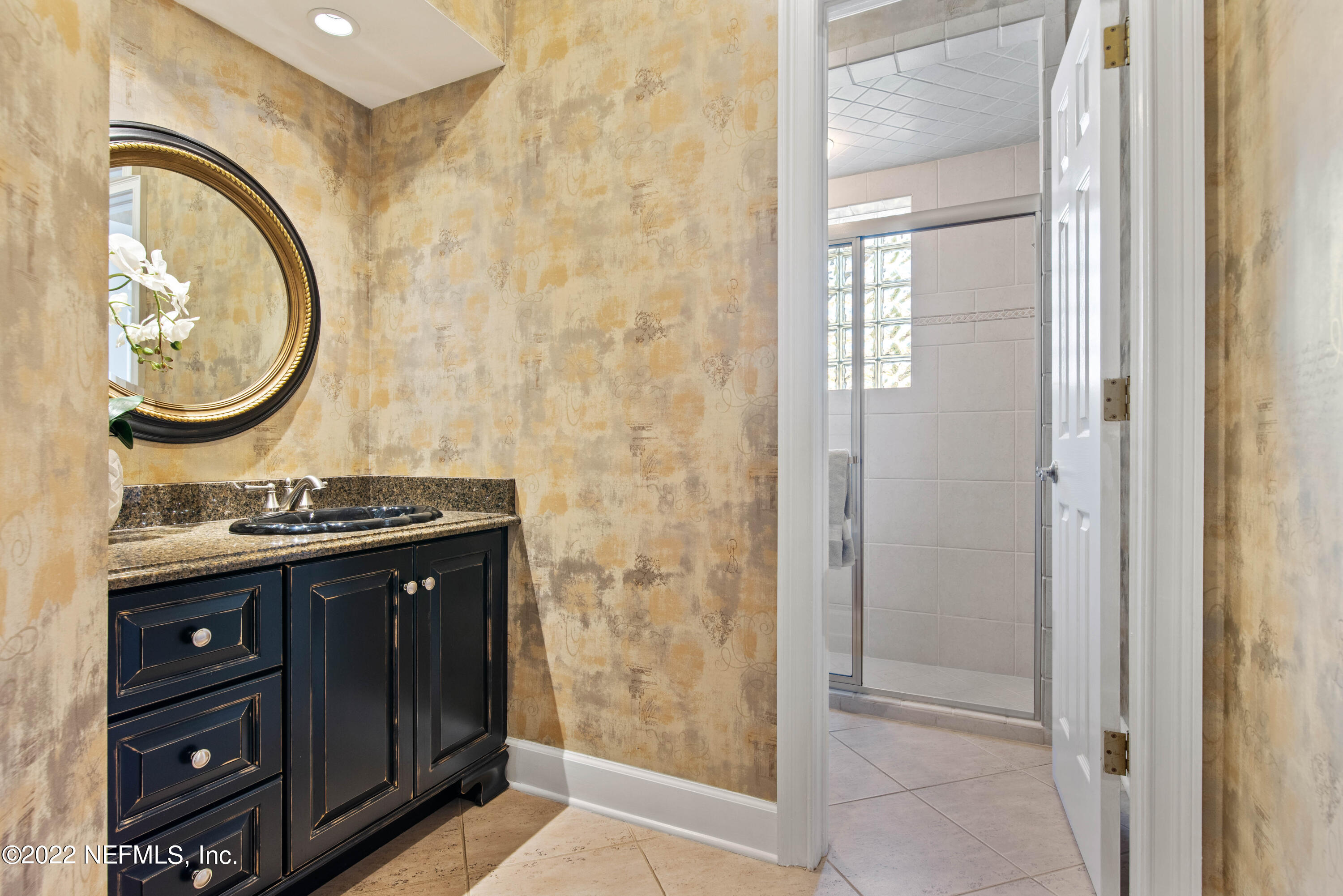 12608 Mandarin Road Jacksonville, FL 32223 - Photo 25 of 55 a bathroom with a sink and a mirror