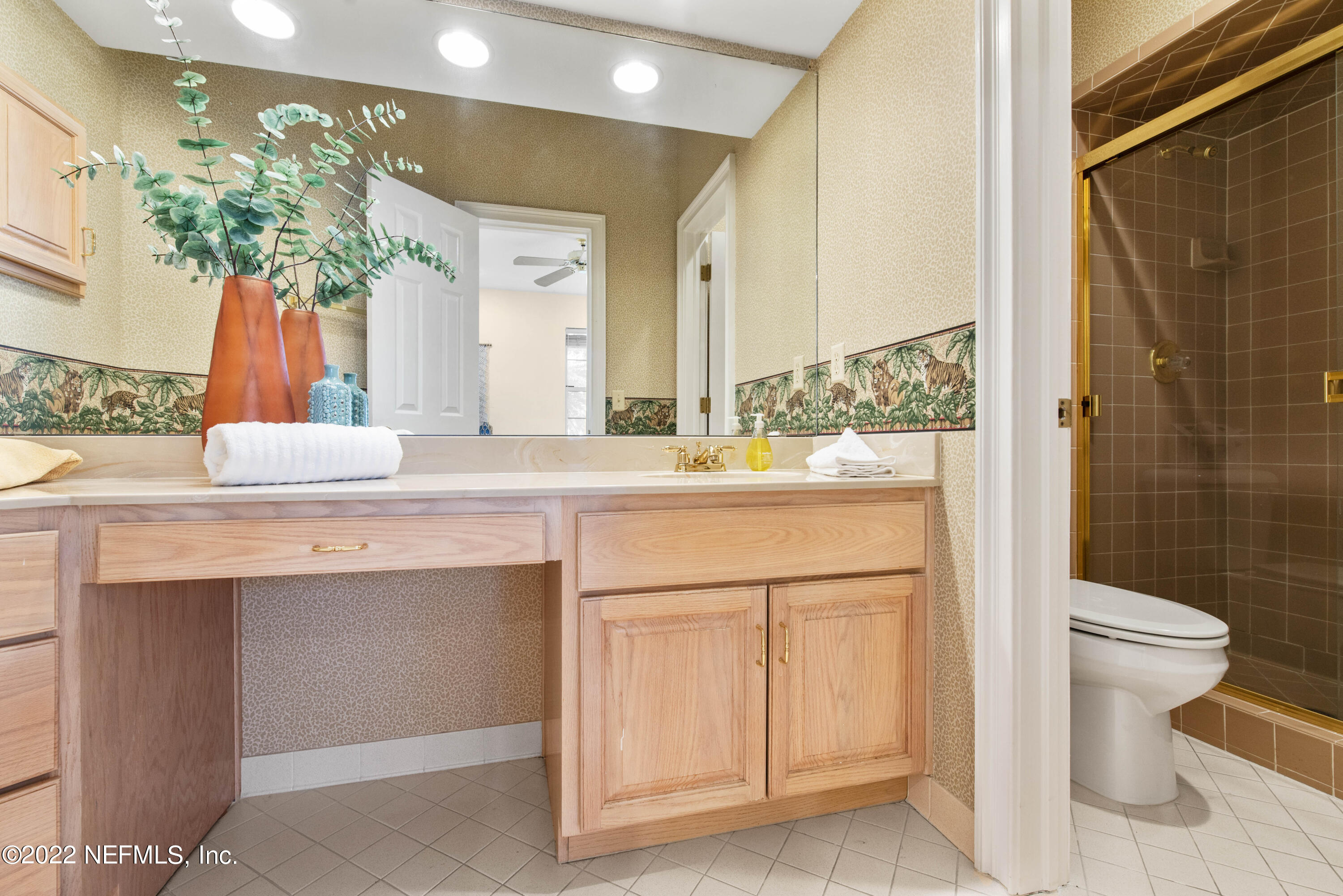 12608 Mandarin Road Jacksonville, FL 32223 - Photo 30 of 55 a bathroom with a sink a toilet and shower