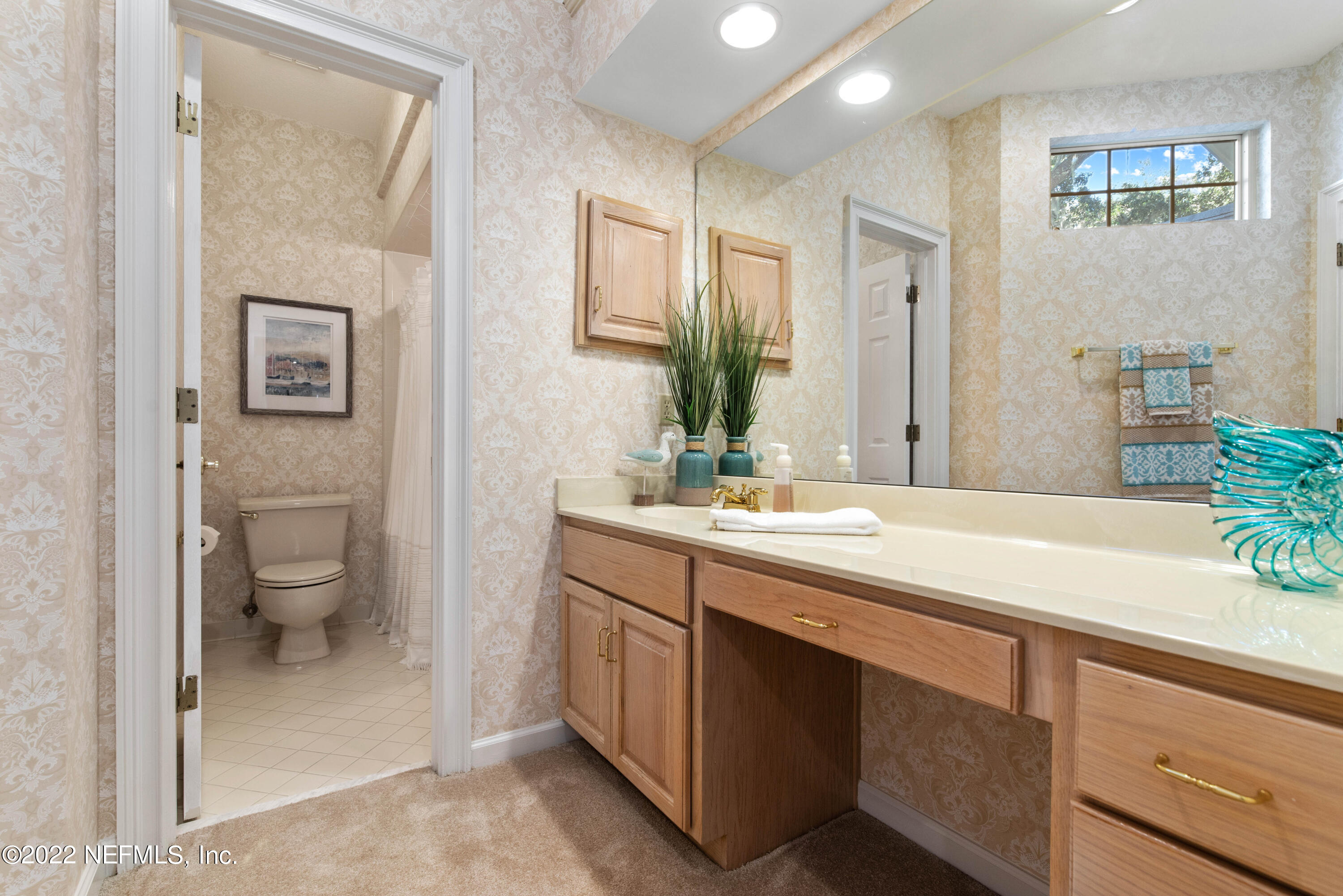 12608 Mandarin Road Jacksonville, FL 32223 - Photo 35 of 55 a spacious bathroom with a granite countertop sink mirror and toilet