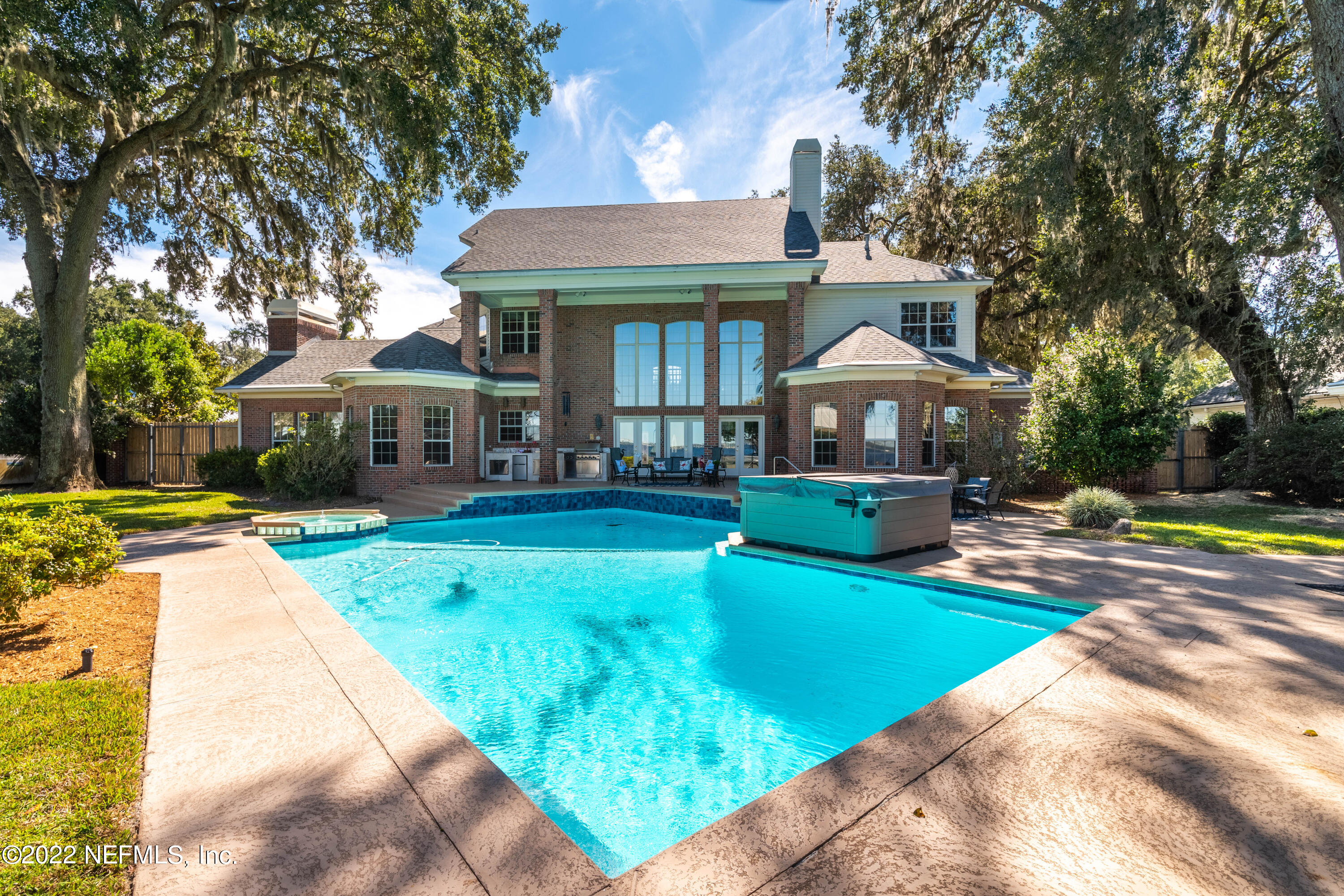 12608 Mandarin Road Jacksonville, FL 32223 - Photo 39 of 55 a front view of a house with swimming pool having outdoor seating