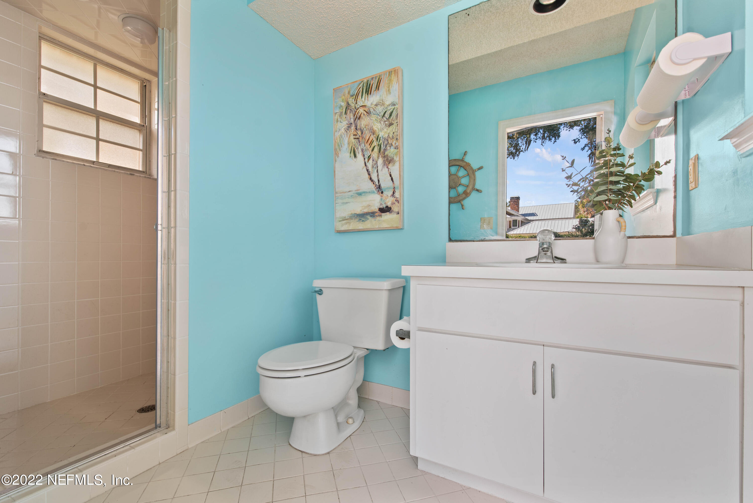 12608 Mandarin Road Jacksonville, FL 32223 - Photo 41 of 55 a bathroom with a sink mirror toilet and next to a window