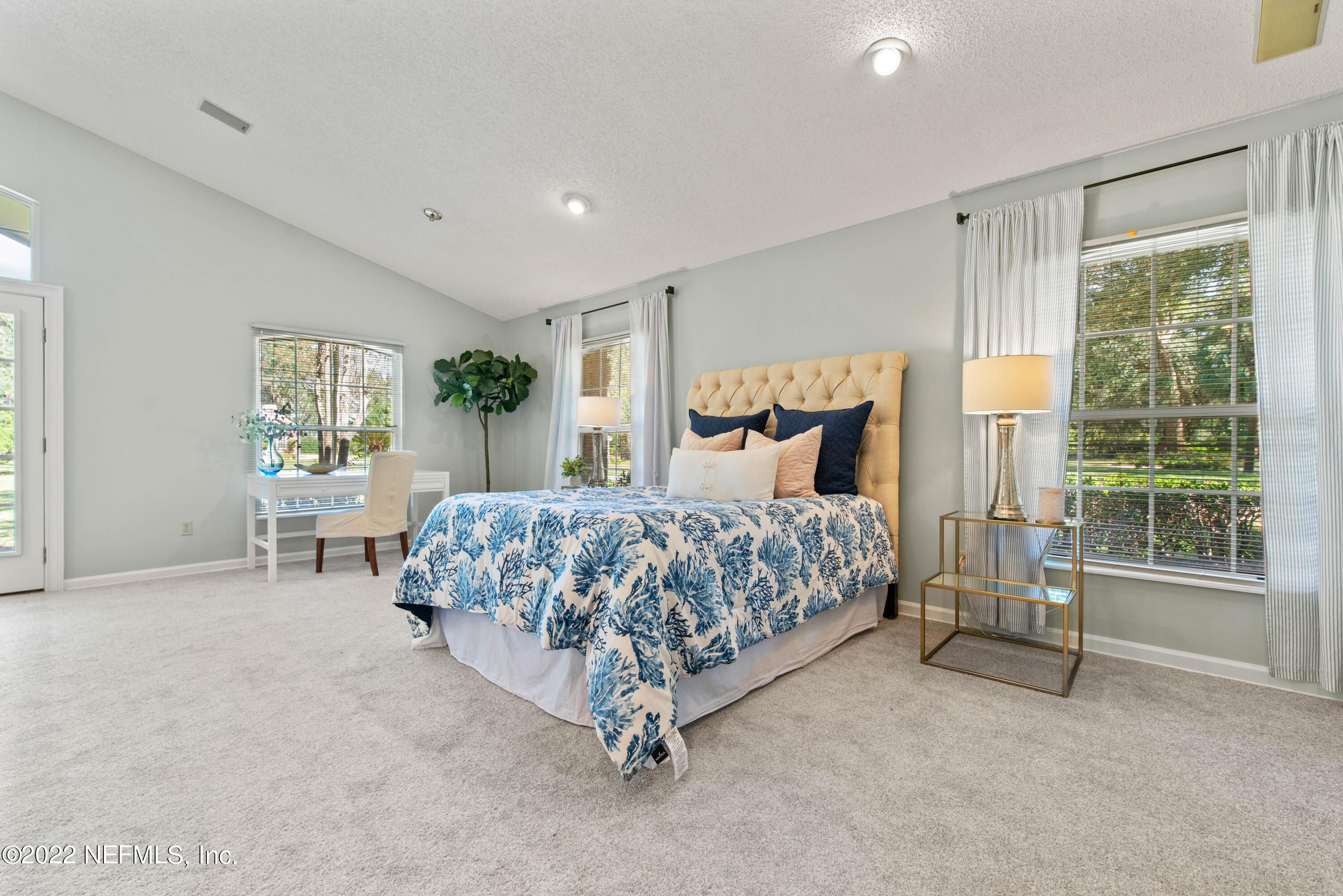 12608 Mandarin Road Jacksonville, FL 32223 - Photo 46 of 55 a bedroom with a large bed and a chandelier