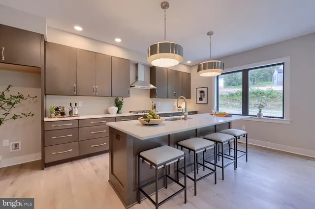 a kitchen with a dining table chairs sink and cabinets
