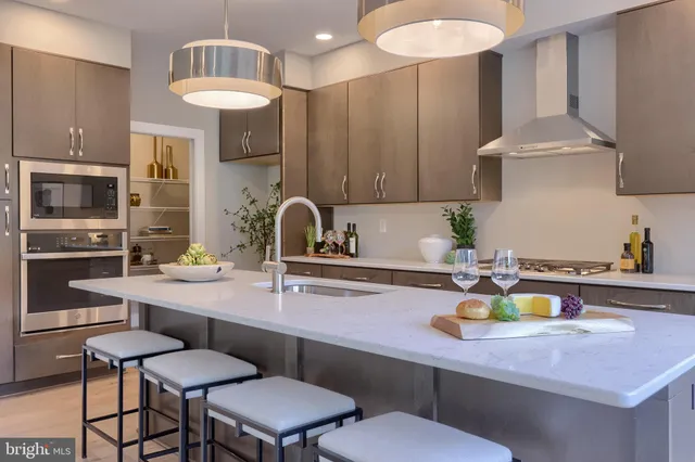 a kitchen with a sink cabinets and appliances