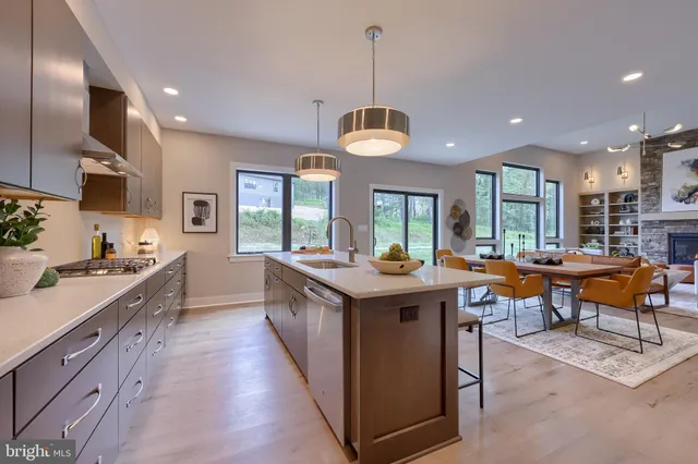 a kitchen with stainless steel appliances granite countertop counter space and wooden floors