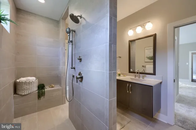 a bathroom with a tub sink and mirror