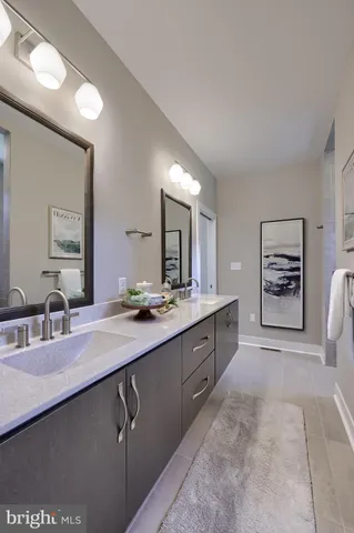 a spacious bathroom with a double vanity sink a mirror a bathtub and a shower