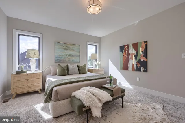 a bedroom with a bed and a painting on the wall