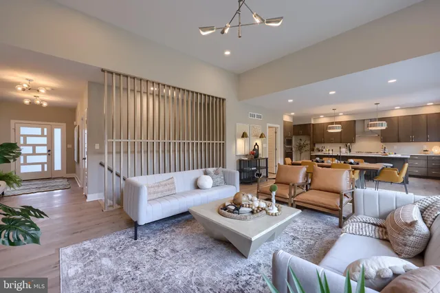 a living room with furniture and kitchen view