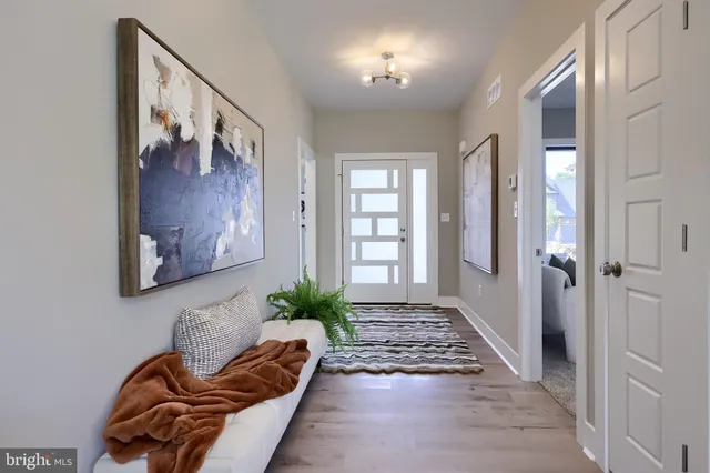 a living room with furniture and potted plant