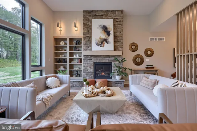 a living room with furniture and a fireplace