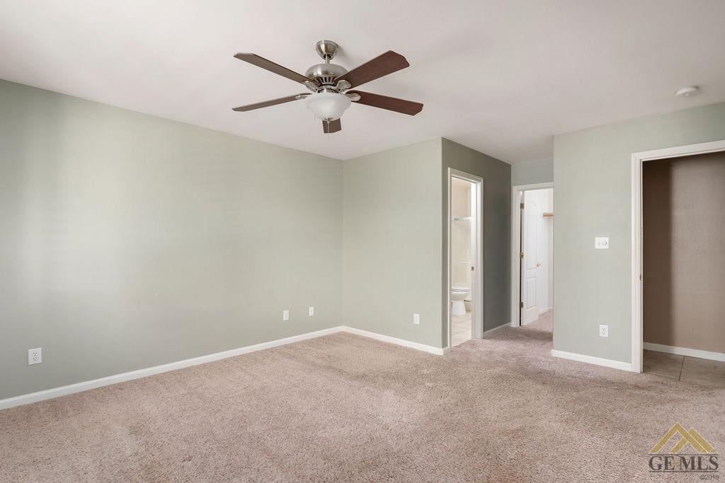 Undisclosed Address Bakersfield, CA 93312 - Photo 12 of 28 an empty room with closet and view of a livingroom
