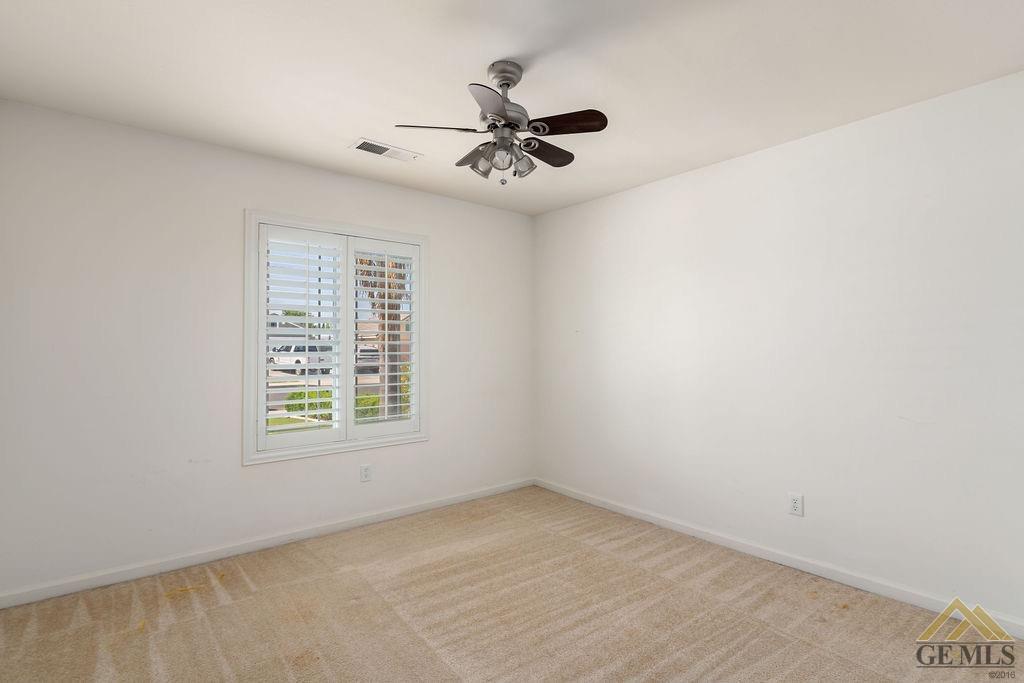 Undisclosed Address Bakersfield, CA 93312 - Photo 15 of 28 an empty room with a window and a ceiling fan