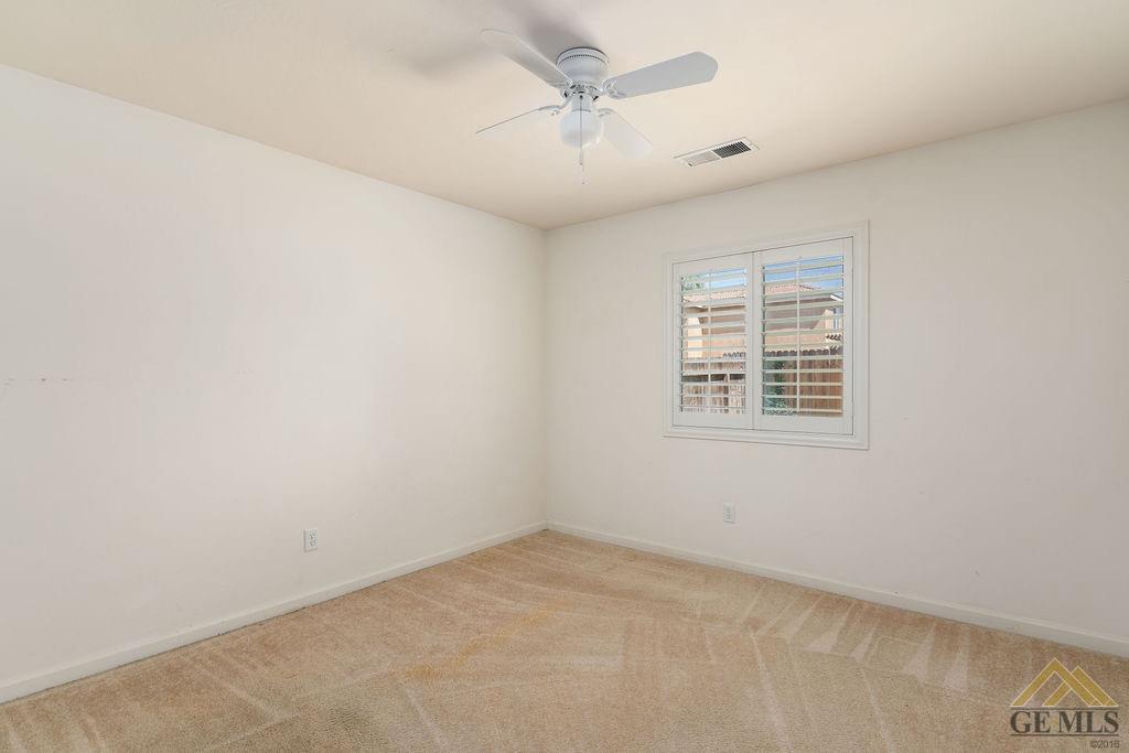 Undisclosed Address Bakersfield, CA 93312 - Photo 16 of 28 an empty room with windows and fan