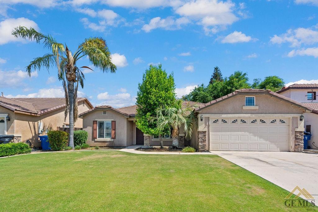 Undisclosed Address Bakersfield, CA 93312 - Photo 2 of 28 a front view of a house with a yard and garage