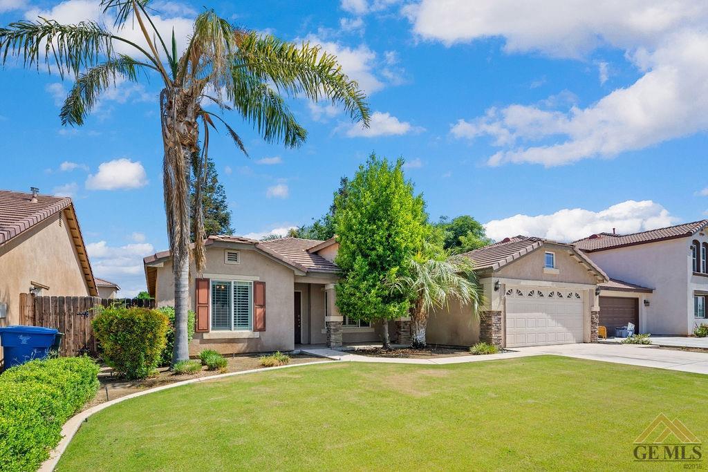 Undisclosed Address Bakersfield, CA 93312 - Photo 3 of 28 a front view of a house with a garden and yard