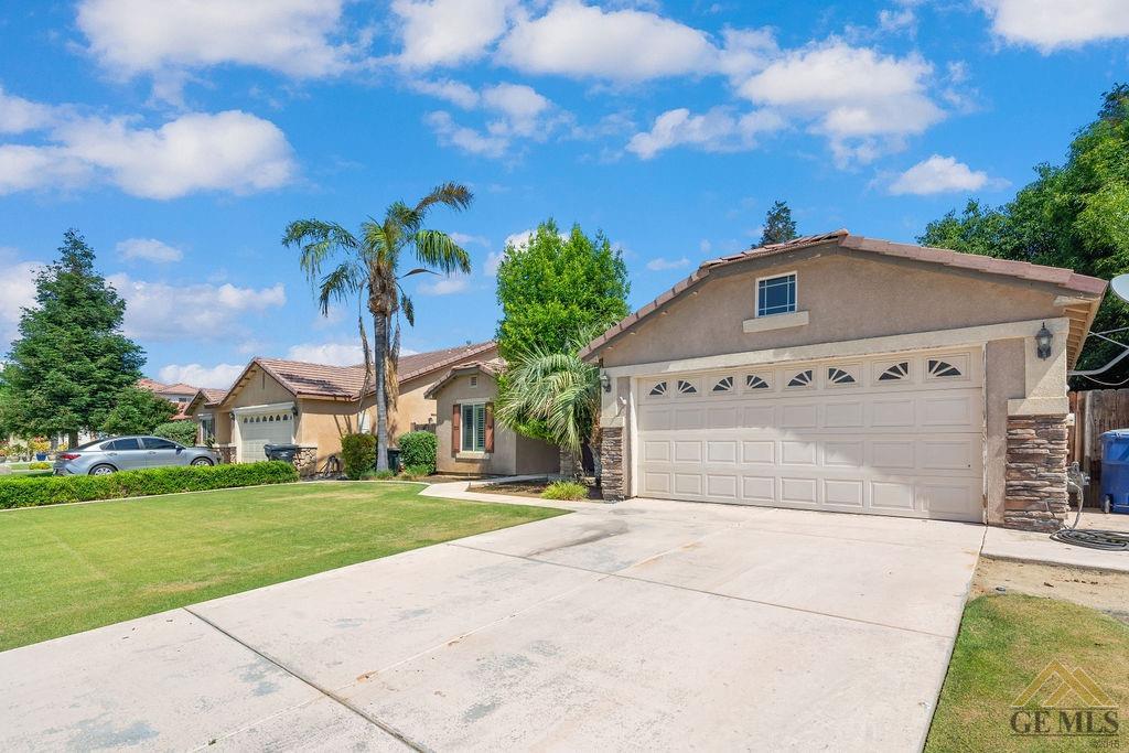 Undisclosed Address Bakersfield, CA 93312 - Photo 4 of 28 a front view of a house with a garden and yard