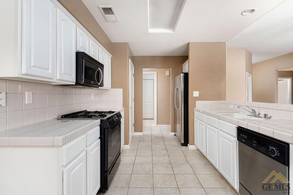 Undisclosed Address Bakersfield, CA 93312 - Photo 8 of 28 a kitchen with stainless steel appliances granite countertop a sink and a stove