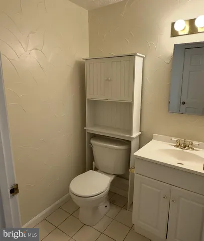 a white toilet sitting next to a bathroom sink