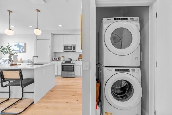 a kitchen with kitchen island a stove a sink and a wooden floors