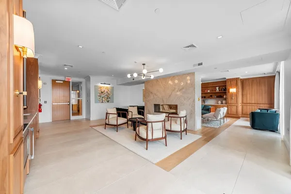 a living room with furniture and kitchen view