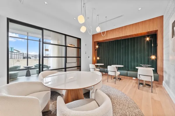 a living room with furniture a table and a large window