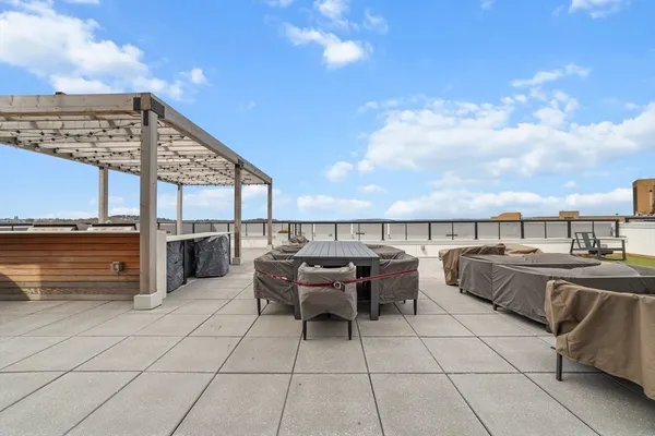 a view of a terrace with lawn chairs