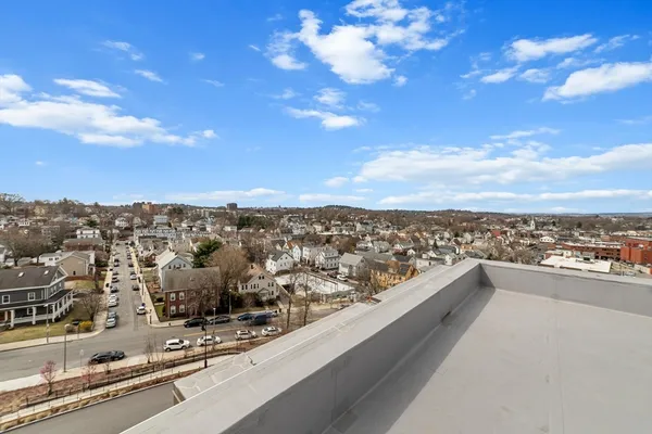 a view of a patio with dining table and chairs with plants